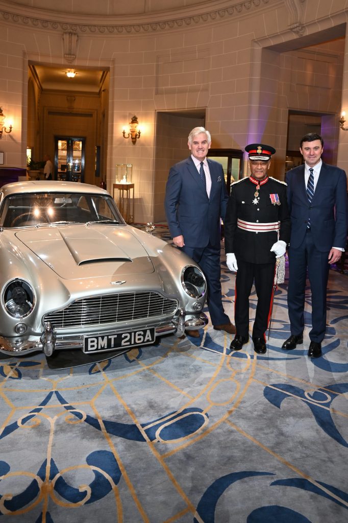 Peter Germain, Sir Ken Olisa and the RAC Secretary & Chief Executive Daniel Pereira with the James Bond Aston Martin